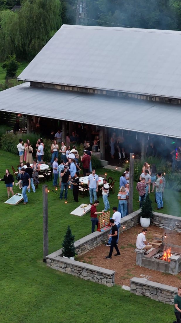 Aerial view of the barn, lawn games, and fire pit