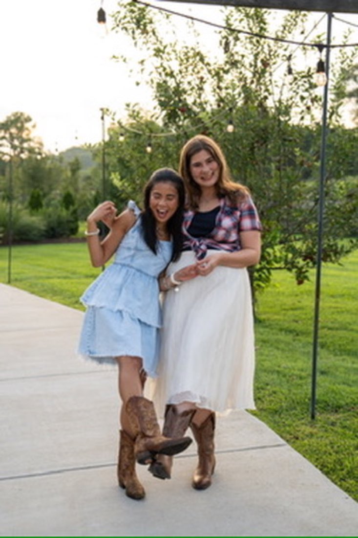 Two friends in cowboy boots on the garden path