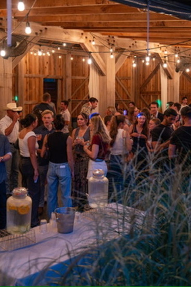 Full house in the barn with drink dispensers up front